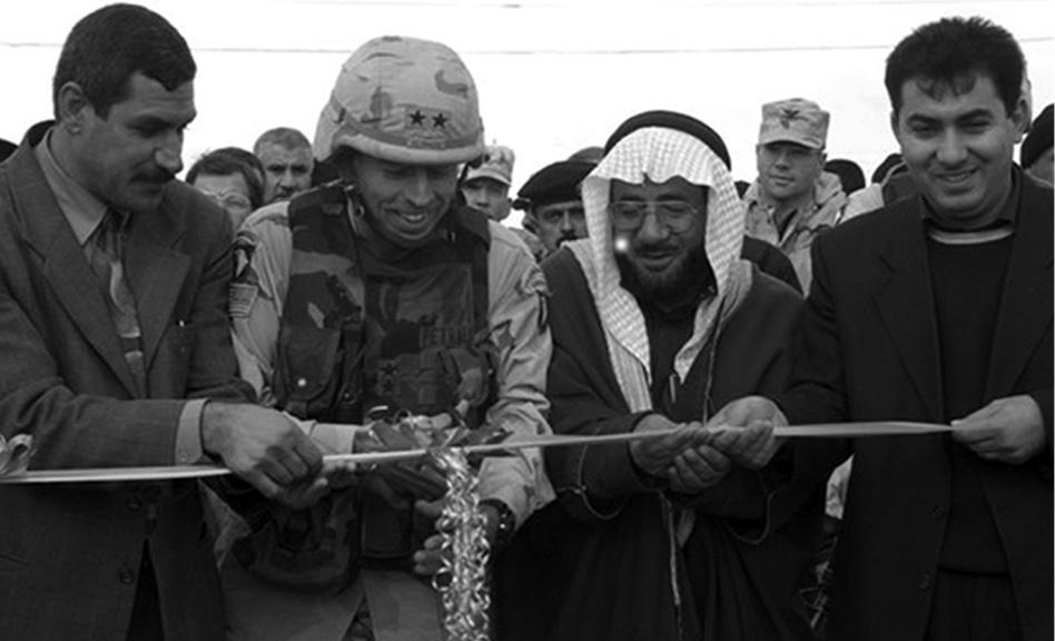 MG David Petraeus and COL Ben Hodges with Arab and Kurdish leaders at a ribbon-cutting ceremony marking the reconstruction of a Kurd-Arab village south of Mosul, 2003.